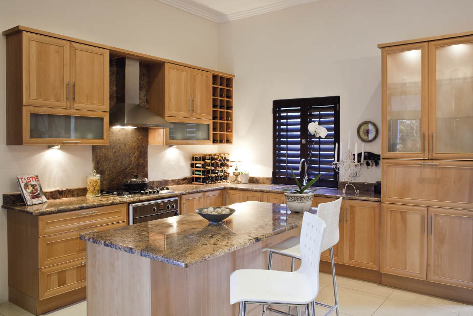  The Kitchen Studio ( 031 462 7722)custom designed this kitchen to fit in with the home owners’ lifestyle. The solid Yugoslavian beech doors complemented their existing furniture, while the interiors were upgraded to a beech melamine finish. The extended Rosa Tier granite worktops allow for casual seating while serving drinks from the flap-down worktop below the glass doors.